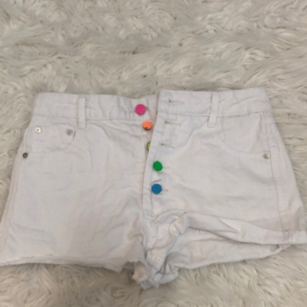White Jean shorts with 5 buttons pink, orange, yellow green, and blue